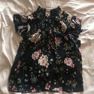 Women’s black blouse with flowers.